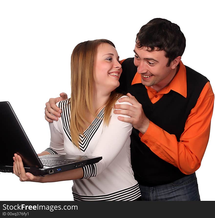 Couple having fun with laptop, pretty blonde and handsome young dark haired man. Couple having fun with laptop, pretty blonde and handsome young dark haired man