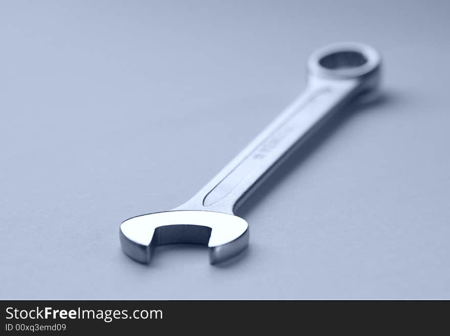 Close-up of a key on painted metal surface with water drops. Close-up of a key on painted metal surface with water drops.