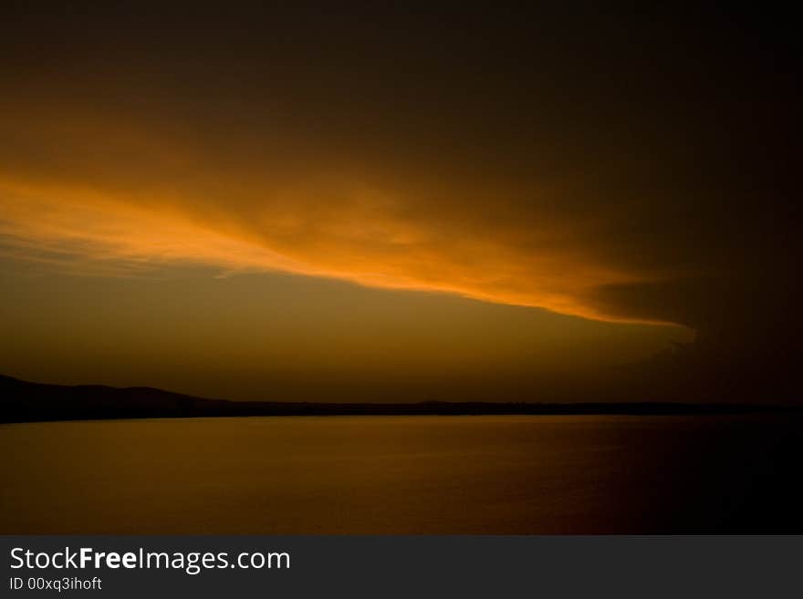 Black sea-Bulgaria-2008 It starts the new day. The sun punctures a road for itself in its oort clouds.Sunrise above the sea