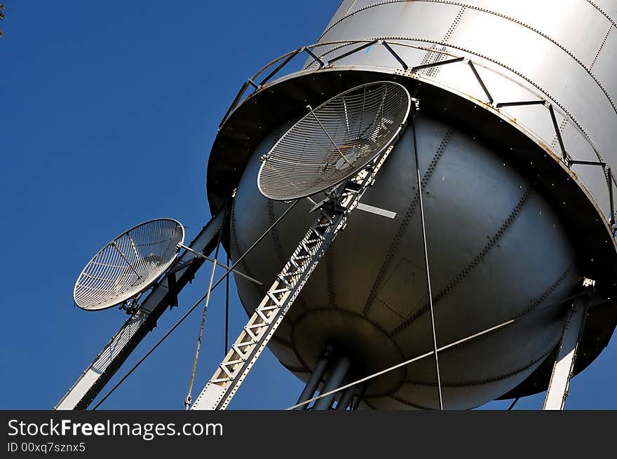 Two Telecommunication Microwave Dishes mounted on Water Tank. Two Telecommunication Microwave Dishes mounted on Water Tank