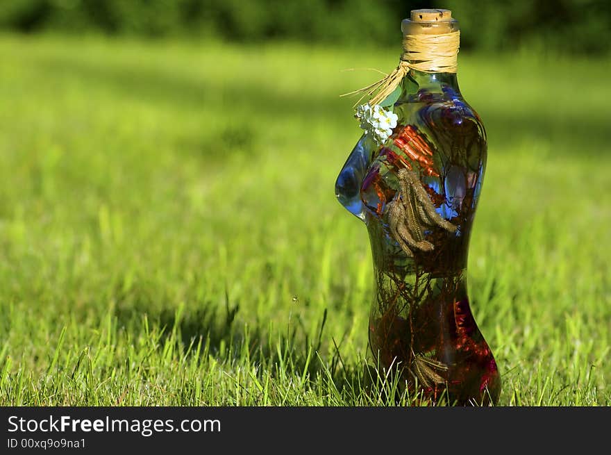 Glass woman with flowers on a background of green lawn. Glass woman with flowers on a background of green lawn