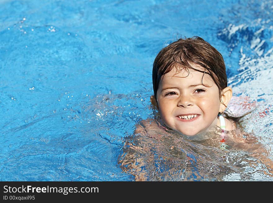 A cute little girl in pool water during the summer. A cute little girl in pool water during the summer