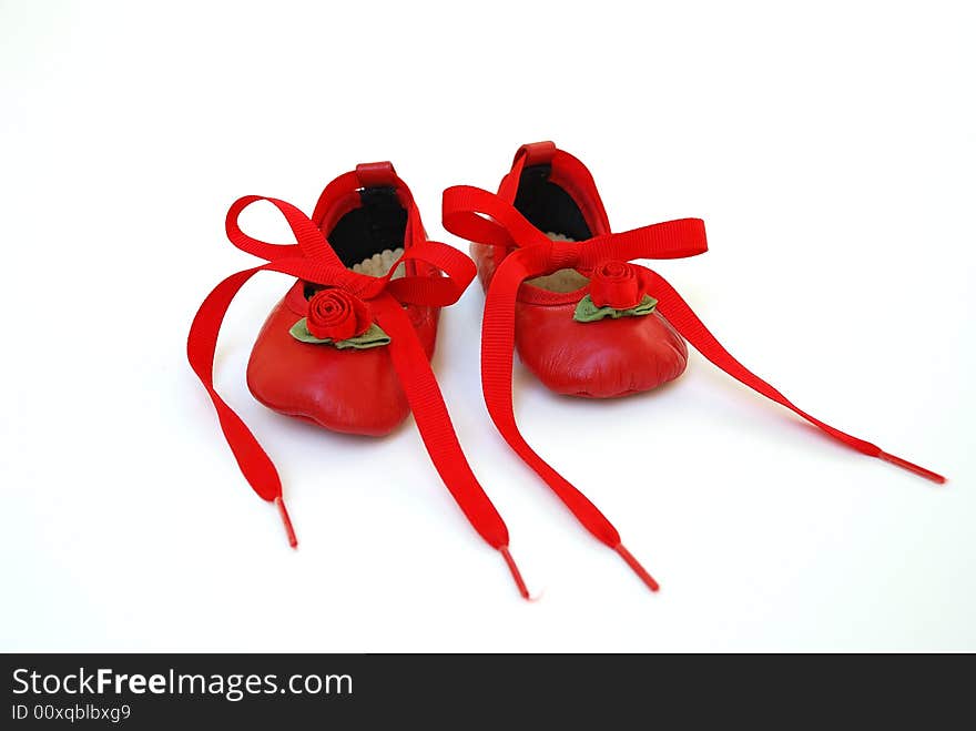 Red shoes with tied ribbon for baby girl and infant. Red shoes with tied ribbon for baby girl and infant.