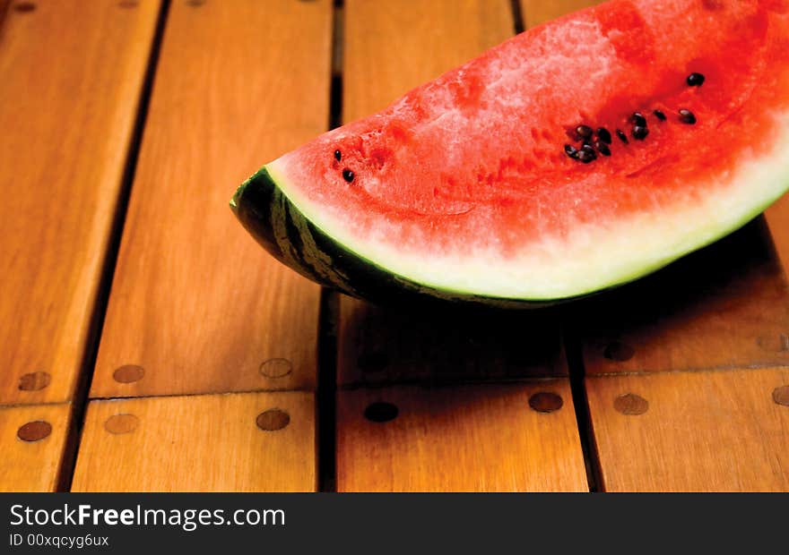 Watermelon on hard wooden floor