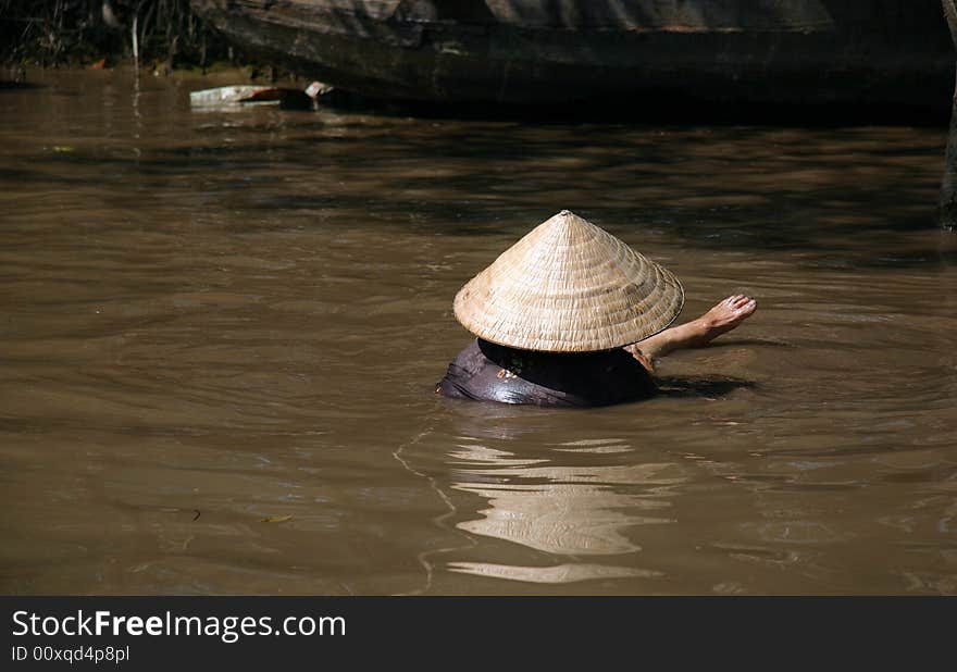 Vietnamese washing in the Mekong River in southern Vietnam