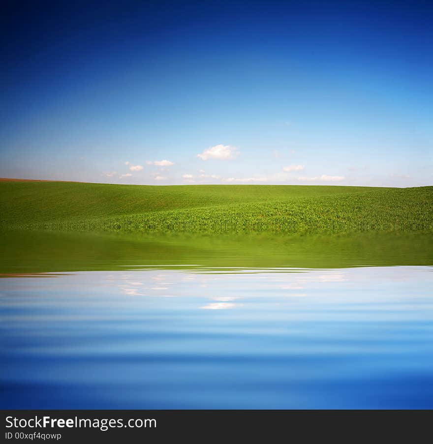 An image of blue sky and green field