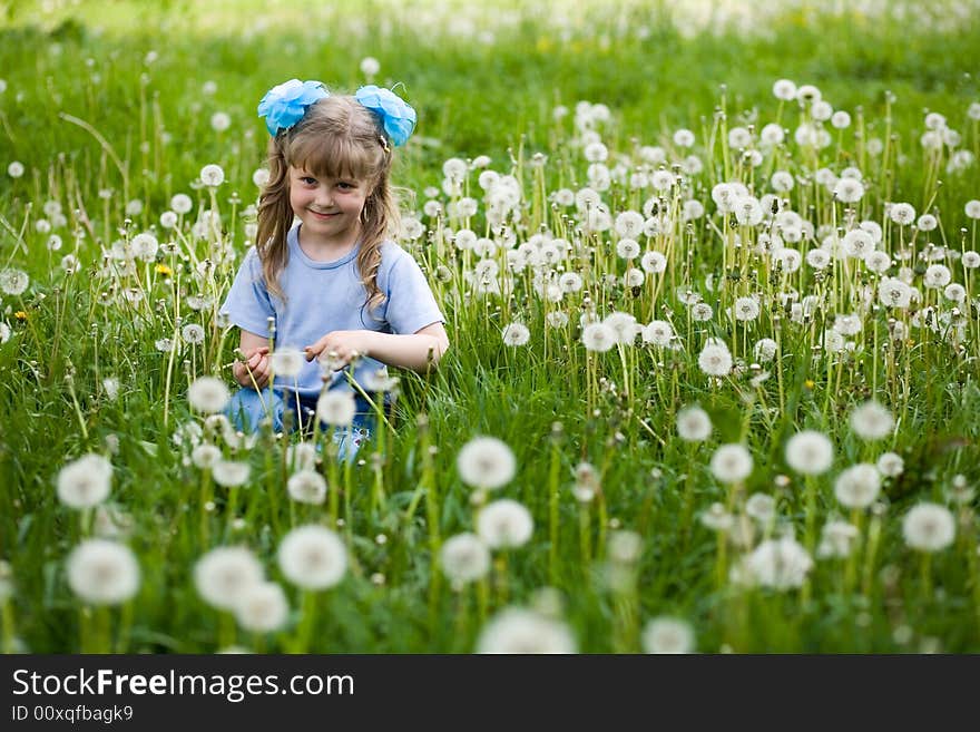 An image of a girl amongst dandelions