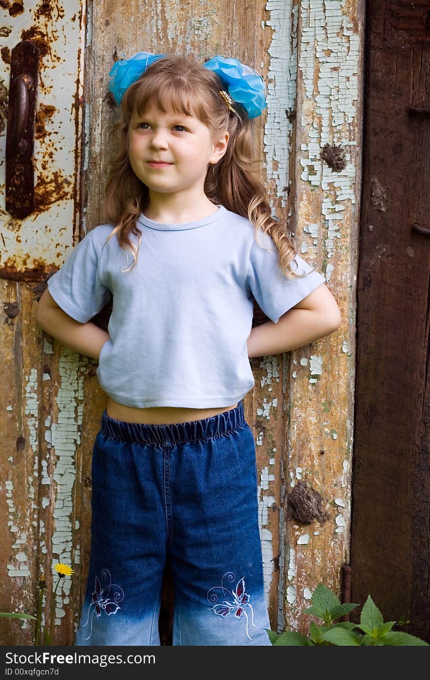 An image of nice girl at old door. An image of nice girl at old door