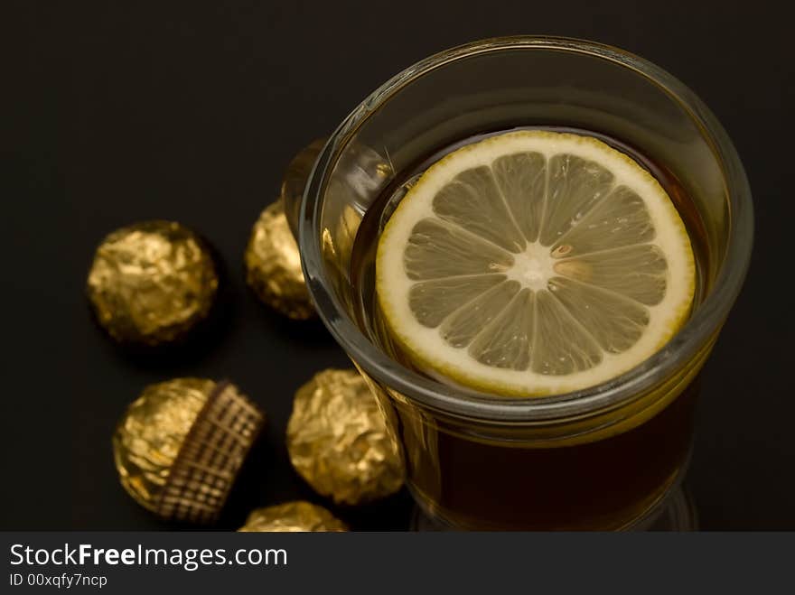 Tea With A Lemon In Glass Chake And Candies