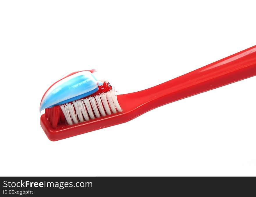 A toothbrush with toothpaste on the bristles. A toothbrush with toothpaste on the bristles