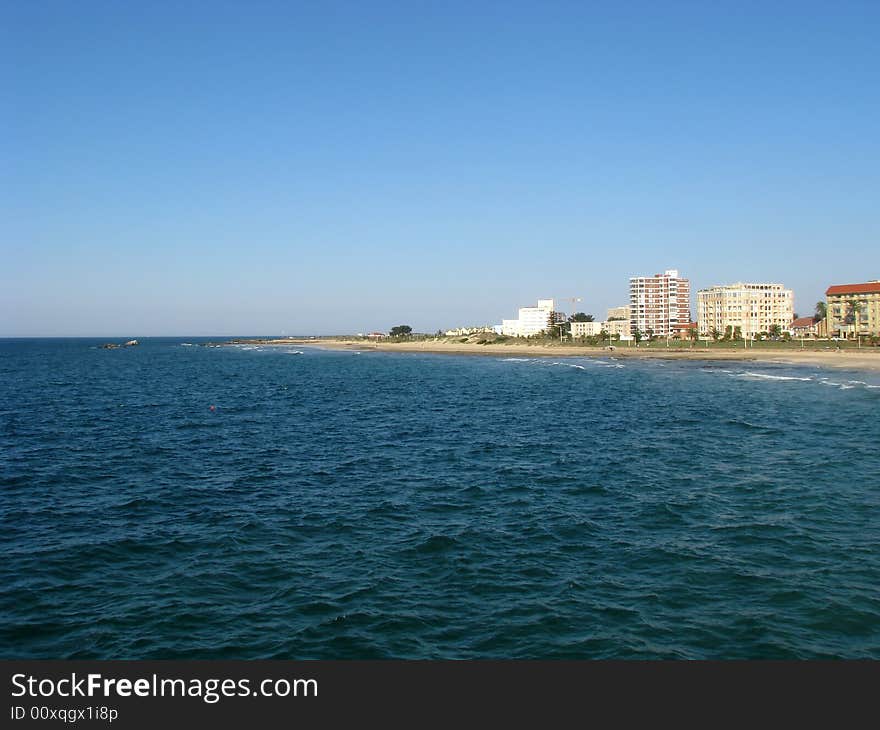 View of city, flats and beach over the sea. View of city, flats and beach over the sea