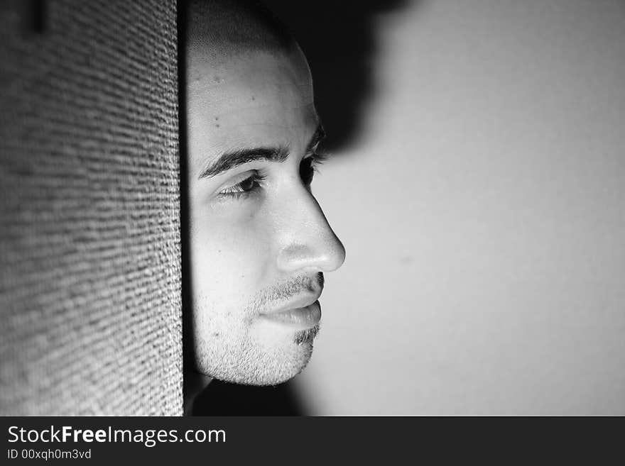 A black and whie photograph of a young man looking ahead.