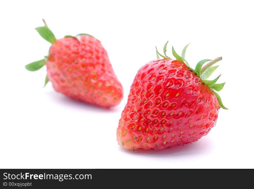 The juicy fresh just washed strawberry on a white background. The juicy fresh just washed strawberry on a white background