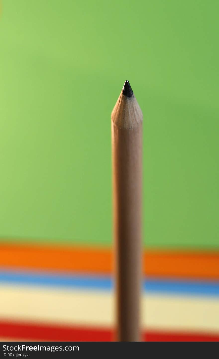 A pencil  with a simple  color background. A pencil  with a simple  color background