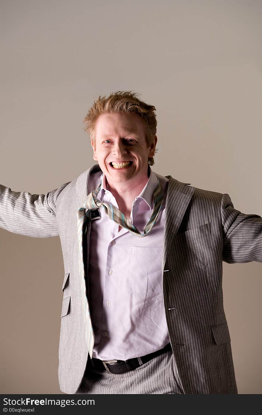 Studio portrait of a middle aged man looking very happy with a loose tie. Studio portrait of a middle aged man looking very happy with a loose tie.