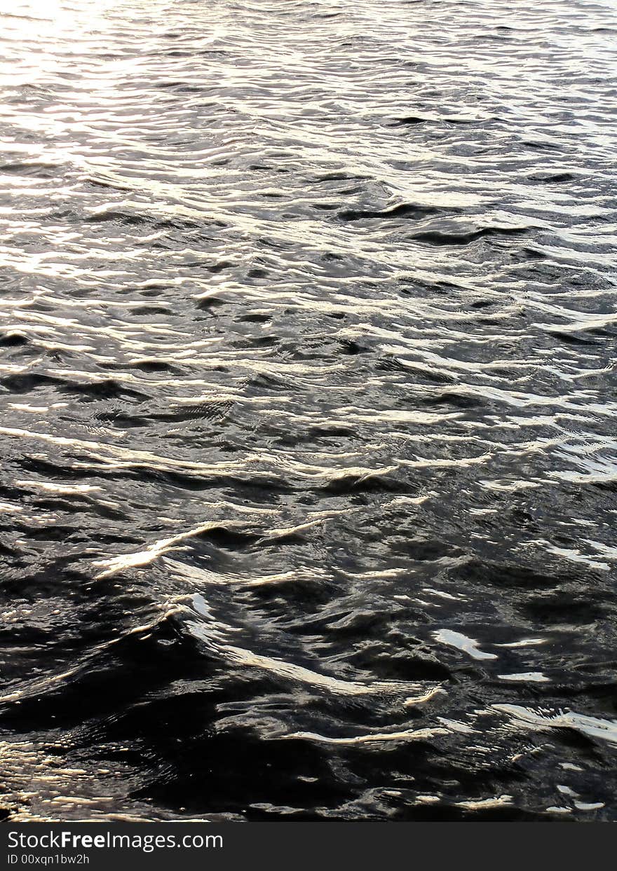 Bright golden sea wave ripples forming a wavy pattern. Bright golden sea wave ripples forming a wavy pattern.