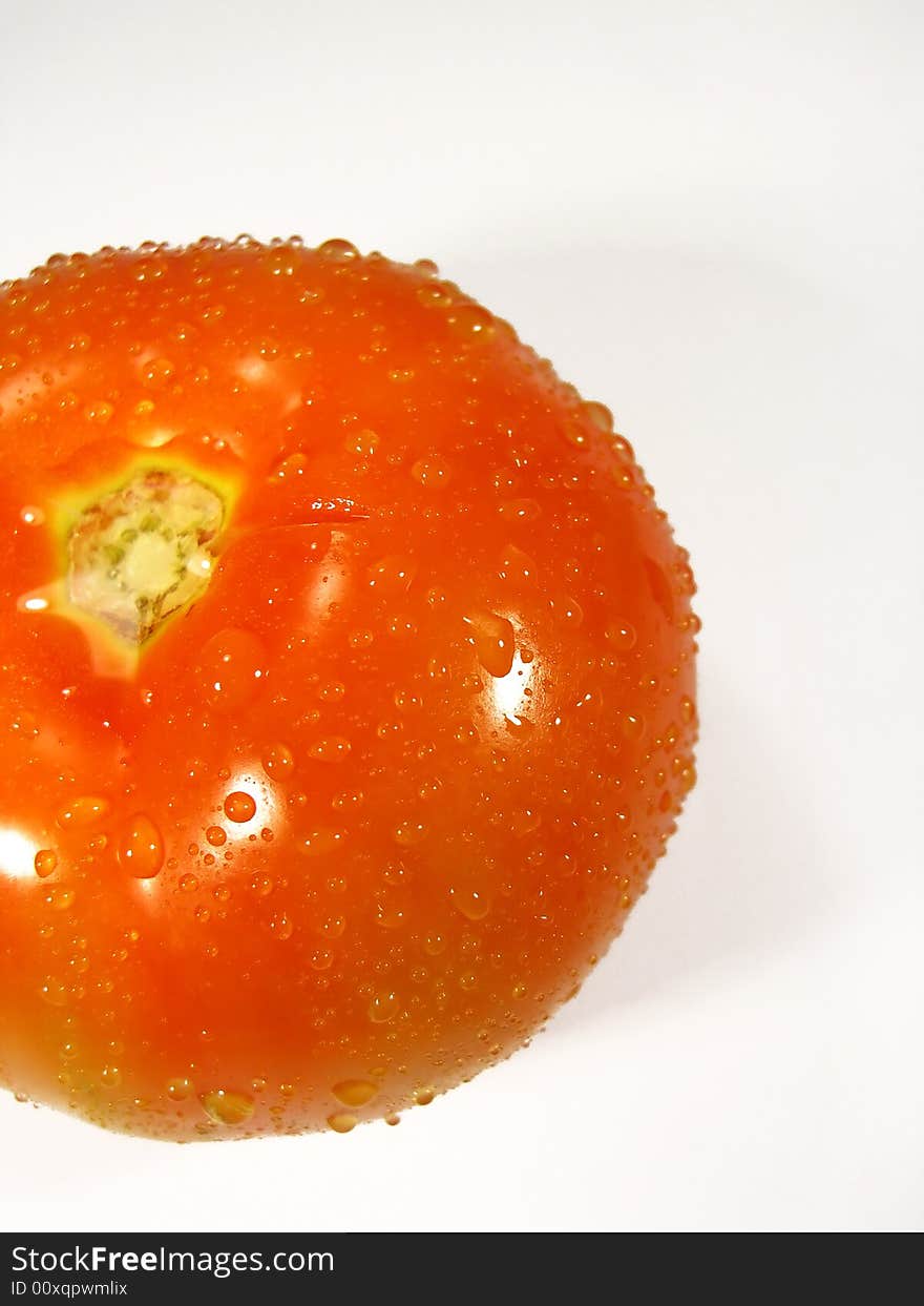 Isolated tomatoe on a white background with droplets of water. Isolated tomatoe on a white background with droplets of water.