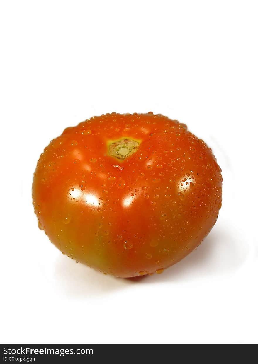 Isolated tomatoe on a white background with droplets of water.