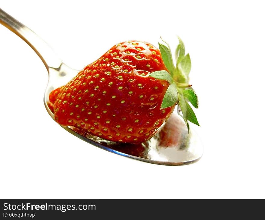 Strawberry with leafs on a spoon on a white background. Strawberry with leafs on a spoon on a white background.