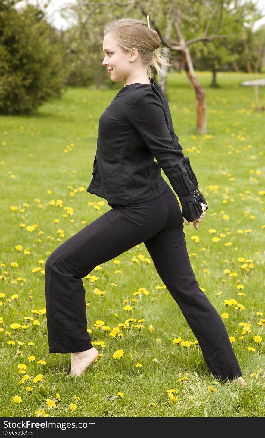 Young Woman Training In The Garden. Young Woman Training In The Garden