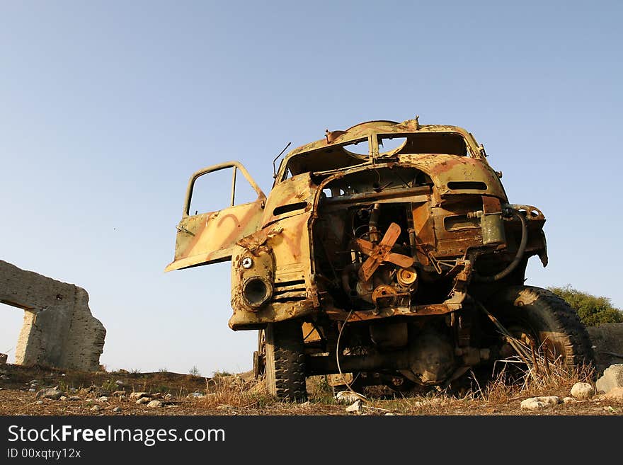 An old wreckage military car in a field