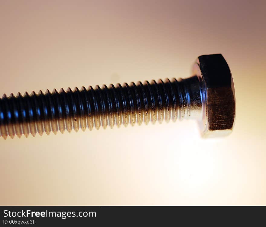 A macro photograph of a hex head screw. A macro photograph of a hex head screw