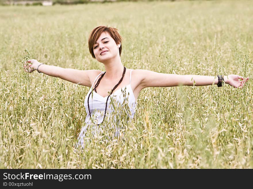 Woman feeling freedom in a field. Woman feeling freedom in a field.