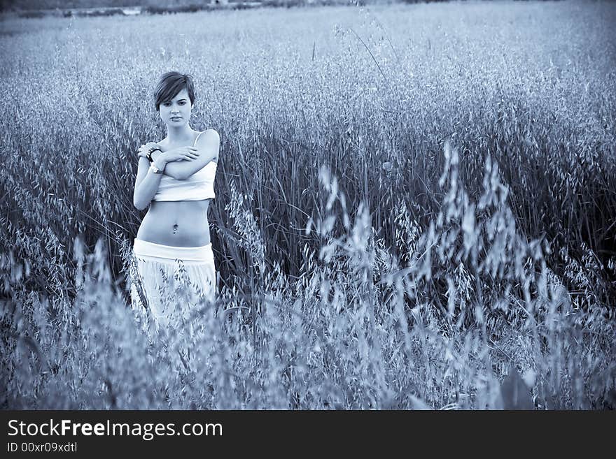 Beautiful woman in the field, blue toned. Beautiful woman in the field, blue toned.