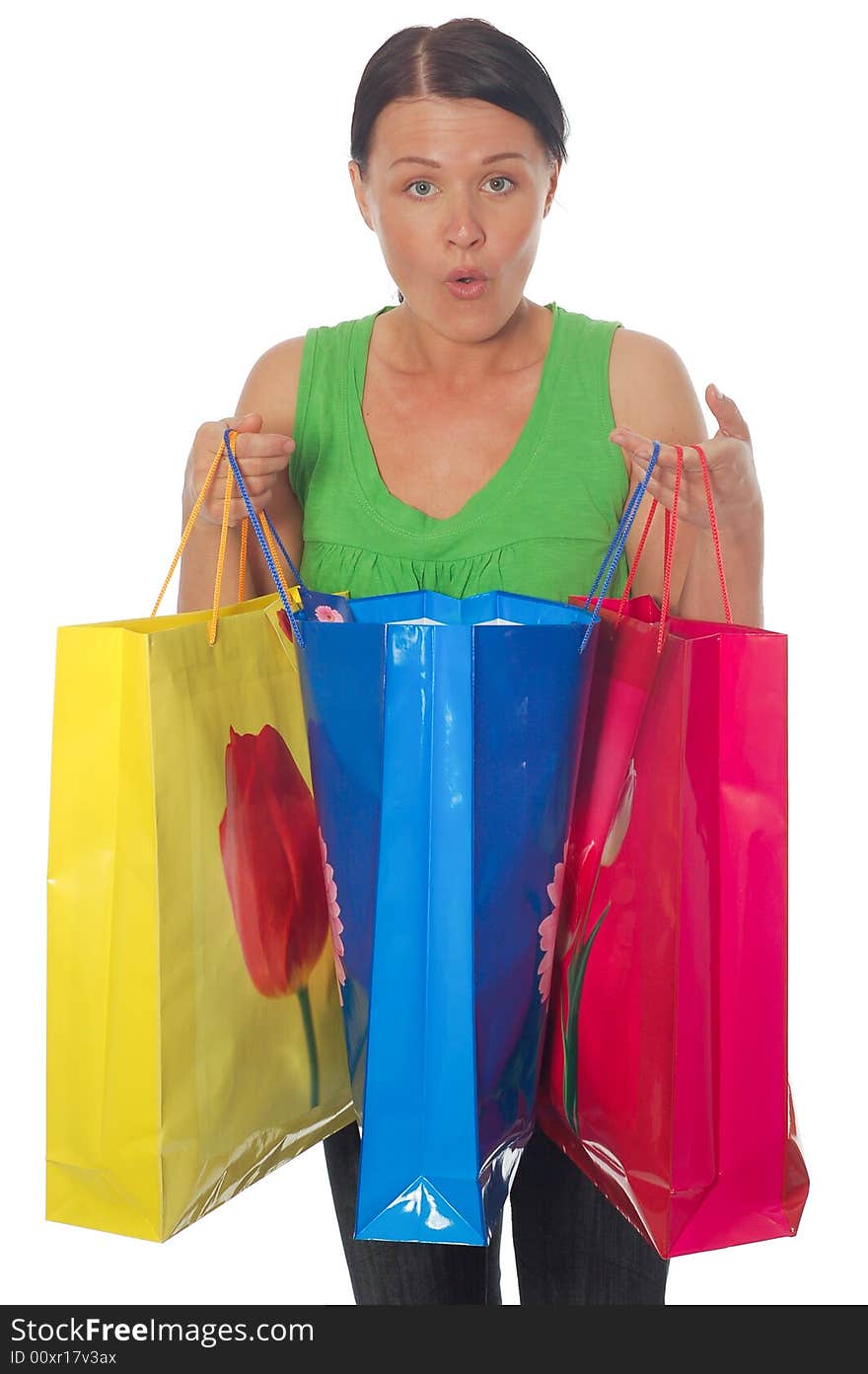 Attractive brunette woman with shopping bags on white background