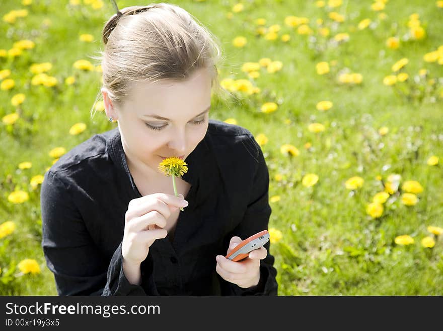 Phone And Flower. Young Woman On The Meadow.