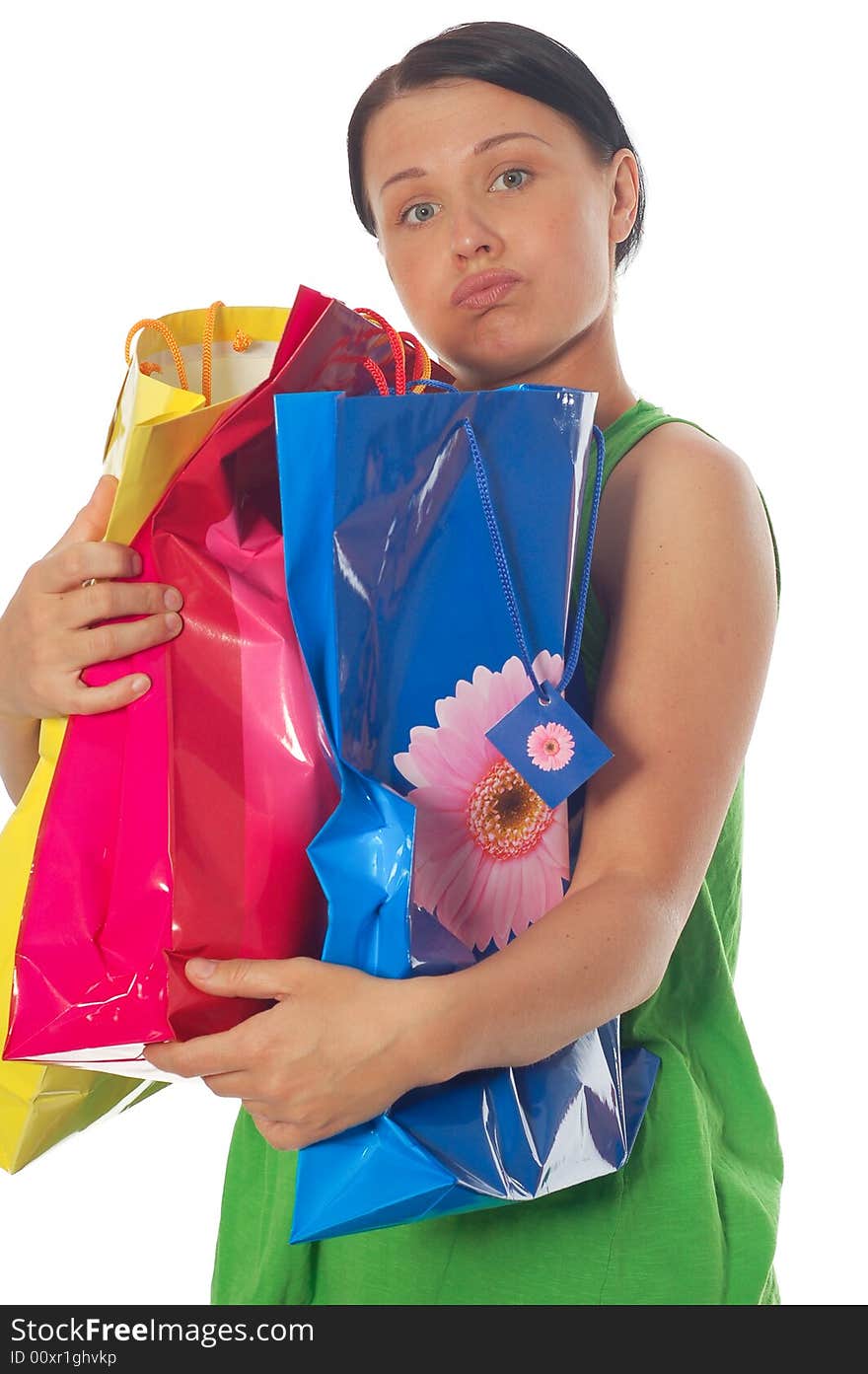 Attractive brunette woman with shopping bags on white background