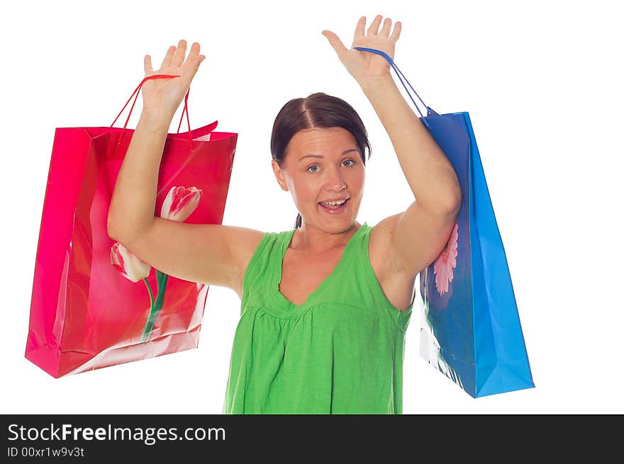 Attractive brunette woman with shopping bags on white background