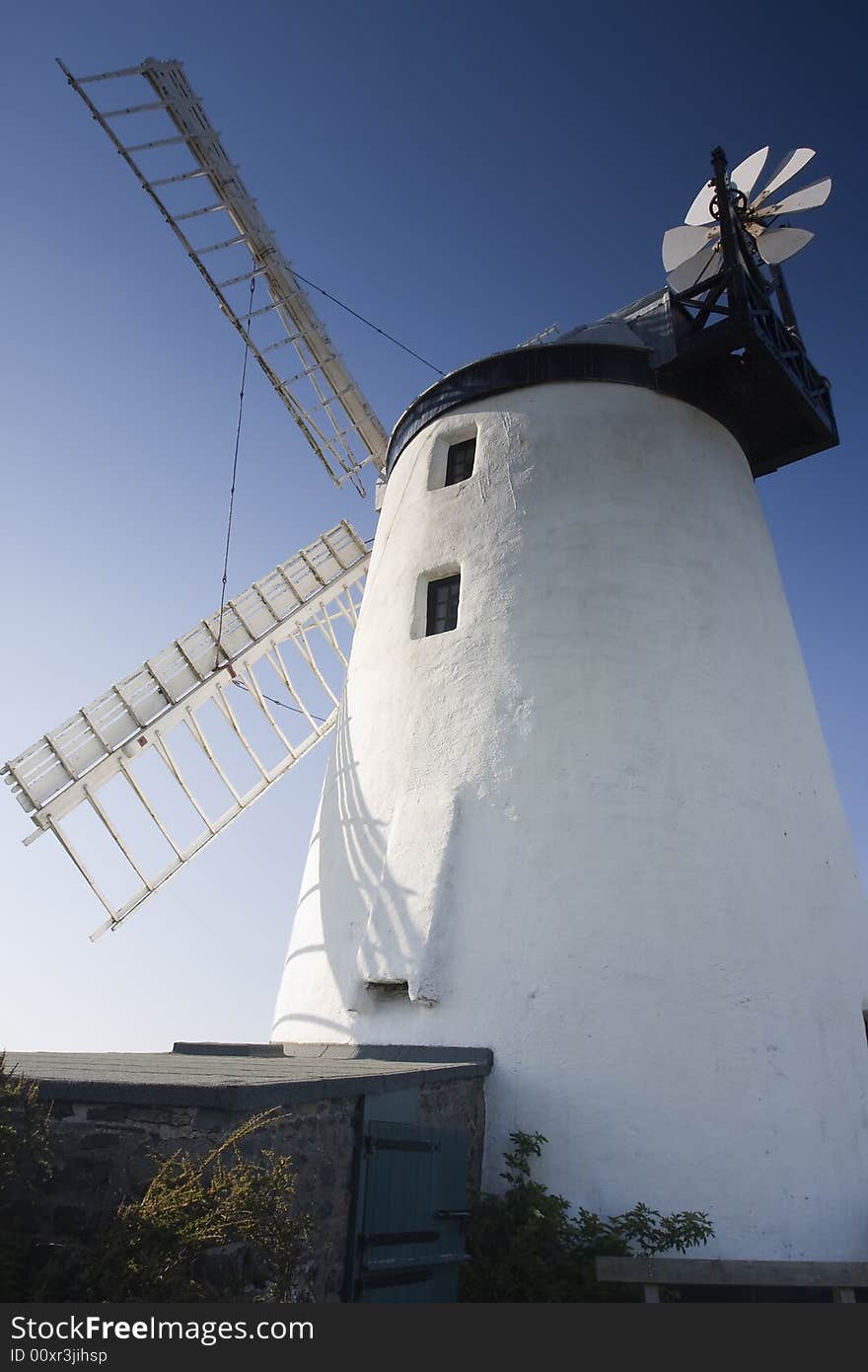 A windmill against a deep blue sky. A windmill against a deep blue sky