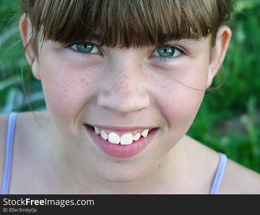 Smiling girl on green meadow