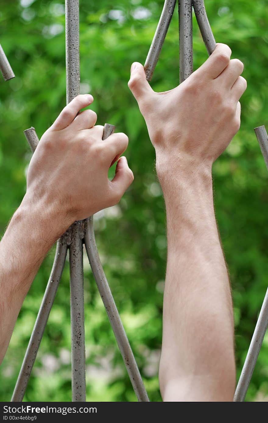 Hands on bar with hope (focus on hand). Hands on bar with hope (focus on hand).