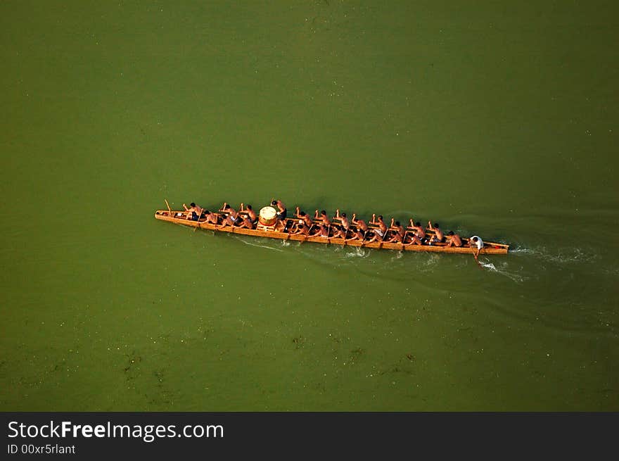 Local people rowing traditional dragon boat on memory of Qv Yuan, the great poet in War-State of China. Local people rowing traditional dragon boat on memory of Qv Yuan, the great poet in War-State of China.