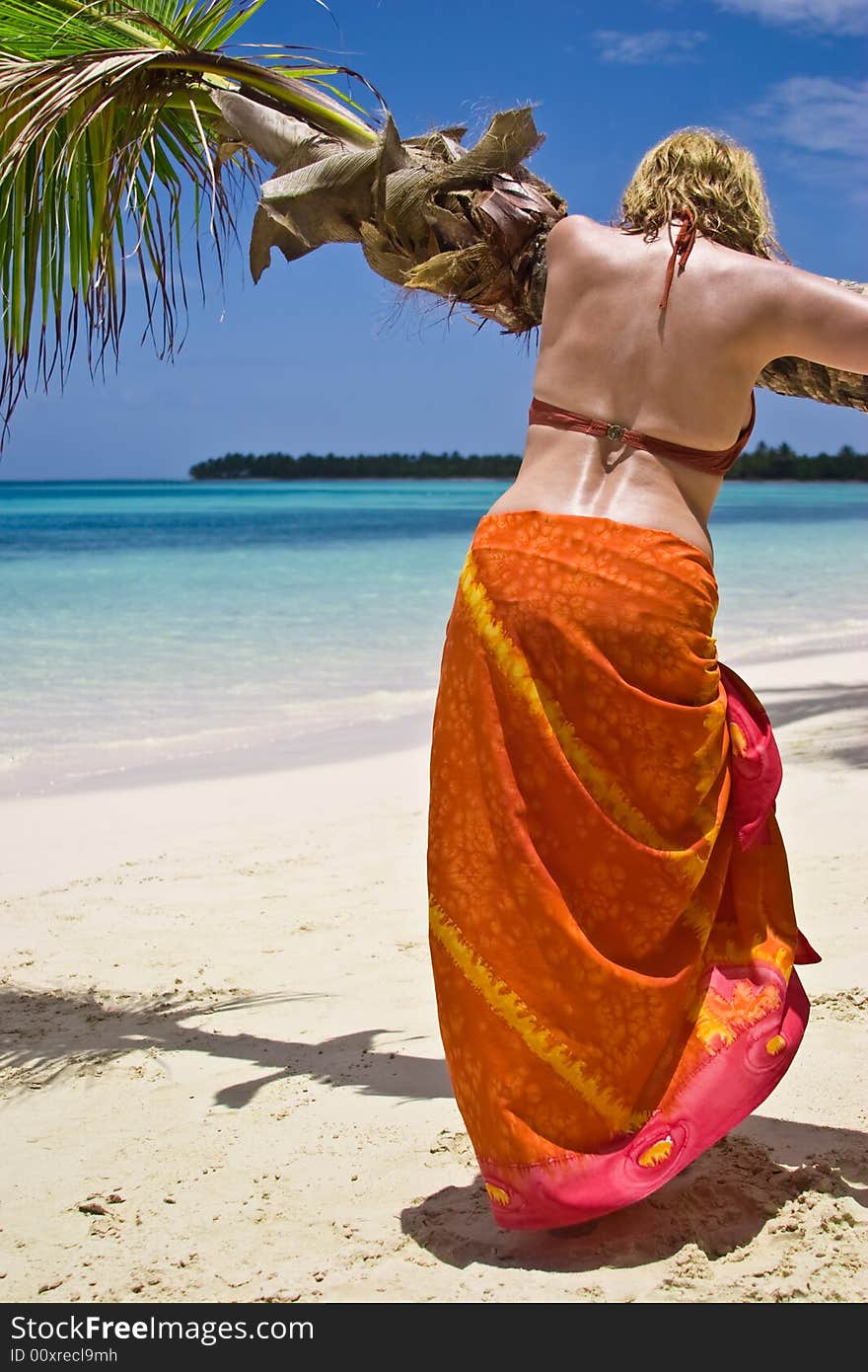 Girl and palm tree on the Bavaro Beach, Dominican republic