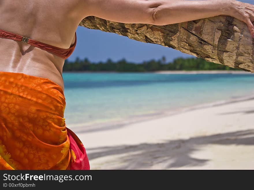 Girl and palm tree on the Bavaro Beach, Dominican republic