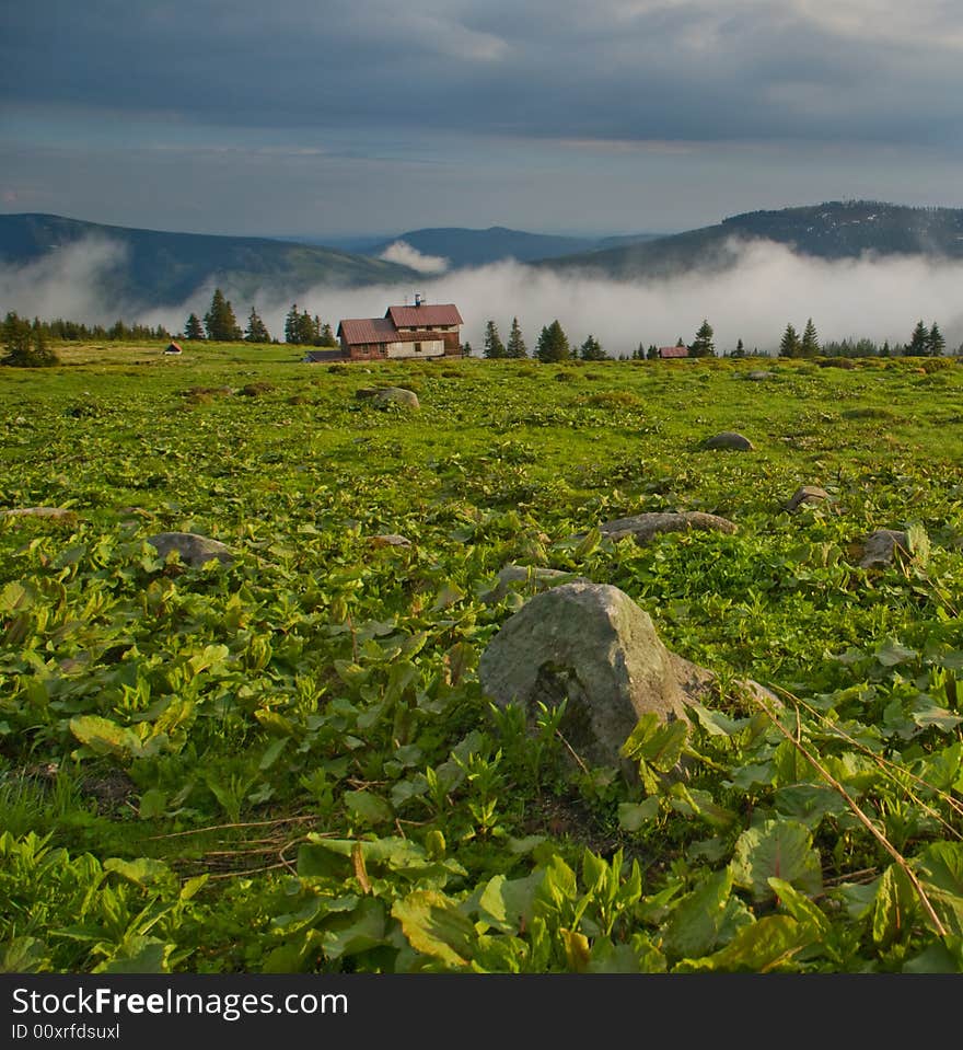 Spring mountain landscape after rain with fog and mysterious sky