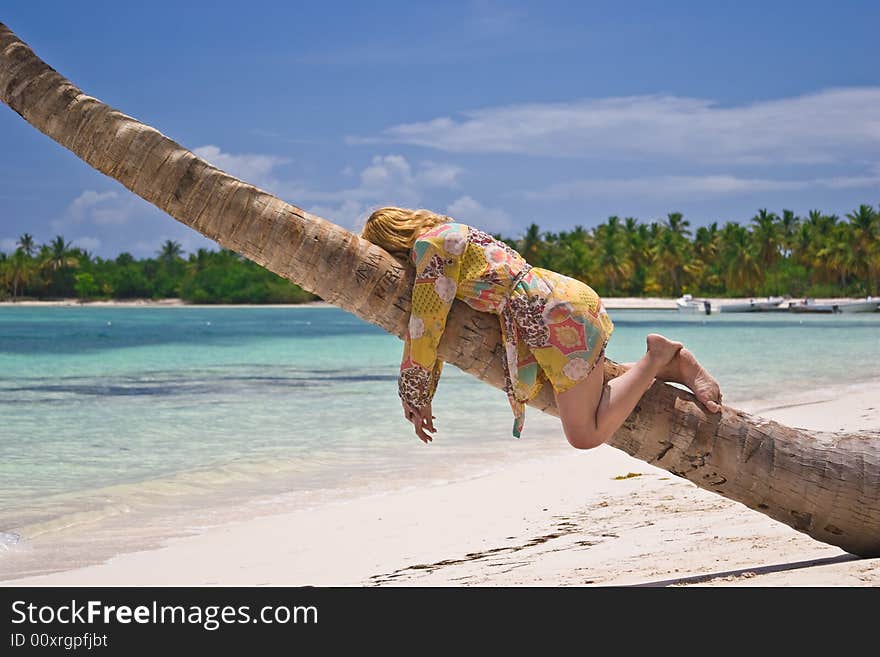 Girl and palm tree on the Bavaro Beach, Dominican republic