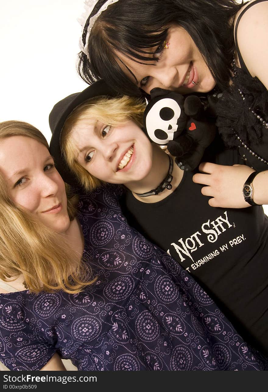 Three happy young girls on white background