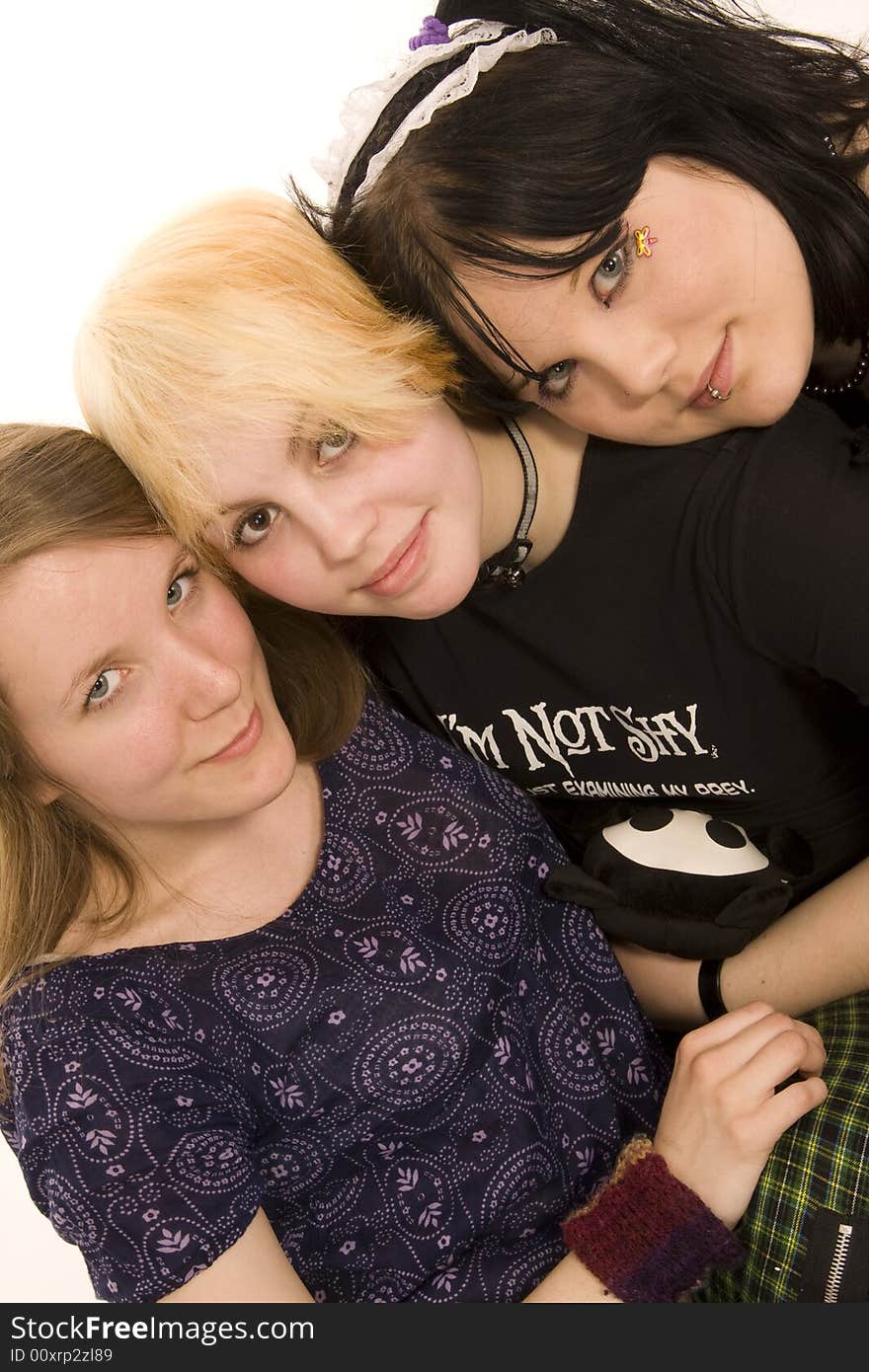 Three happy young girls on white background