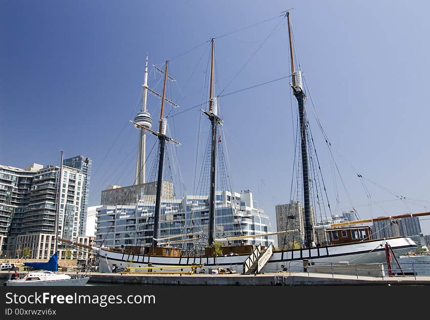 A marina at the lakeshore in city of Toronto and the CN Tower in the background. A marina at the lakeshore in city of Toronto and the CN Tower in the background