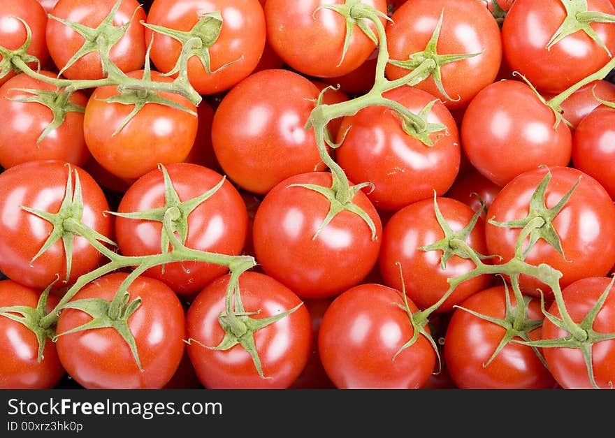 Frame filled with cherry tomatoes on green stems