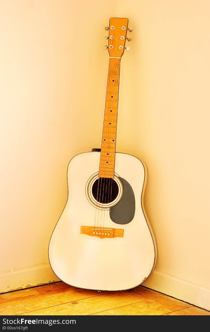 Very old Acoustic Guitar with worn strings.