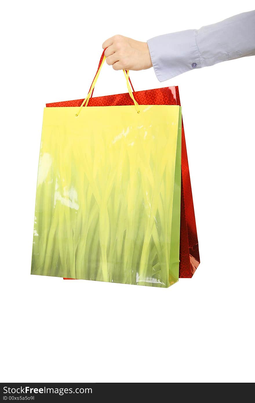 Isolated shot of hand of casual woman hand over bags of gift. concept for holiday or present. Isolated shot of hand of casual woman hand over bags of gift. concept for holiday or present