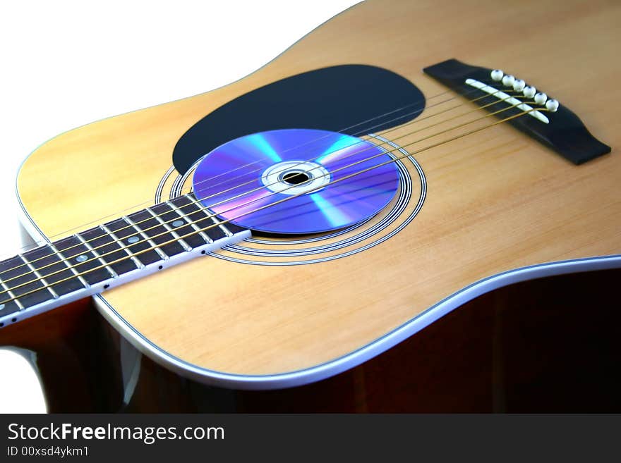 Guitar with audio disc on white background