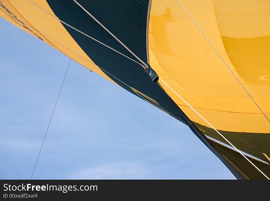 A detail of a yellow hot air balloon in the sky