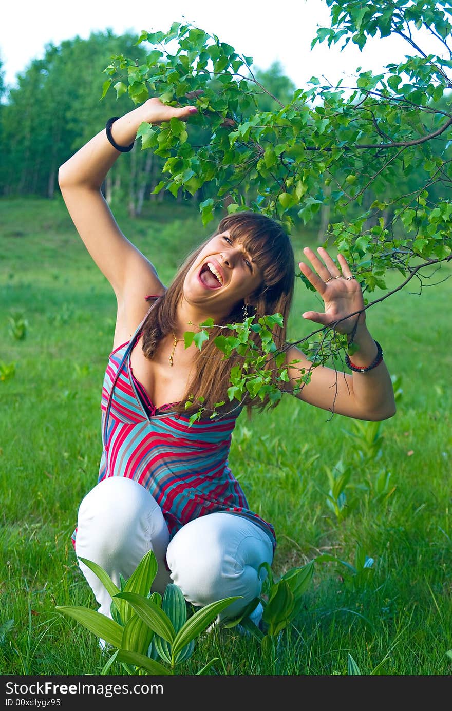 Young adult girl spend her time in nature with leaves of birch. Young adult girl spend her time in nature with leaves of birch