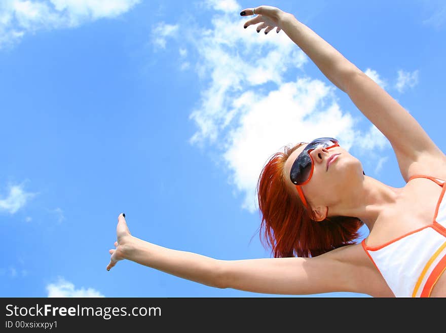 Young redhead girl and blue sky. Young redhead girl and blue sky